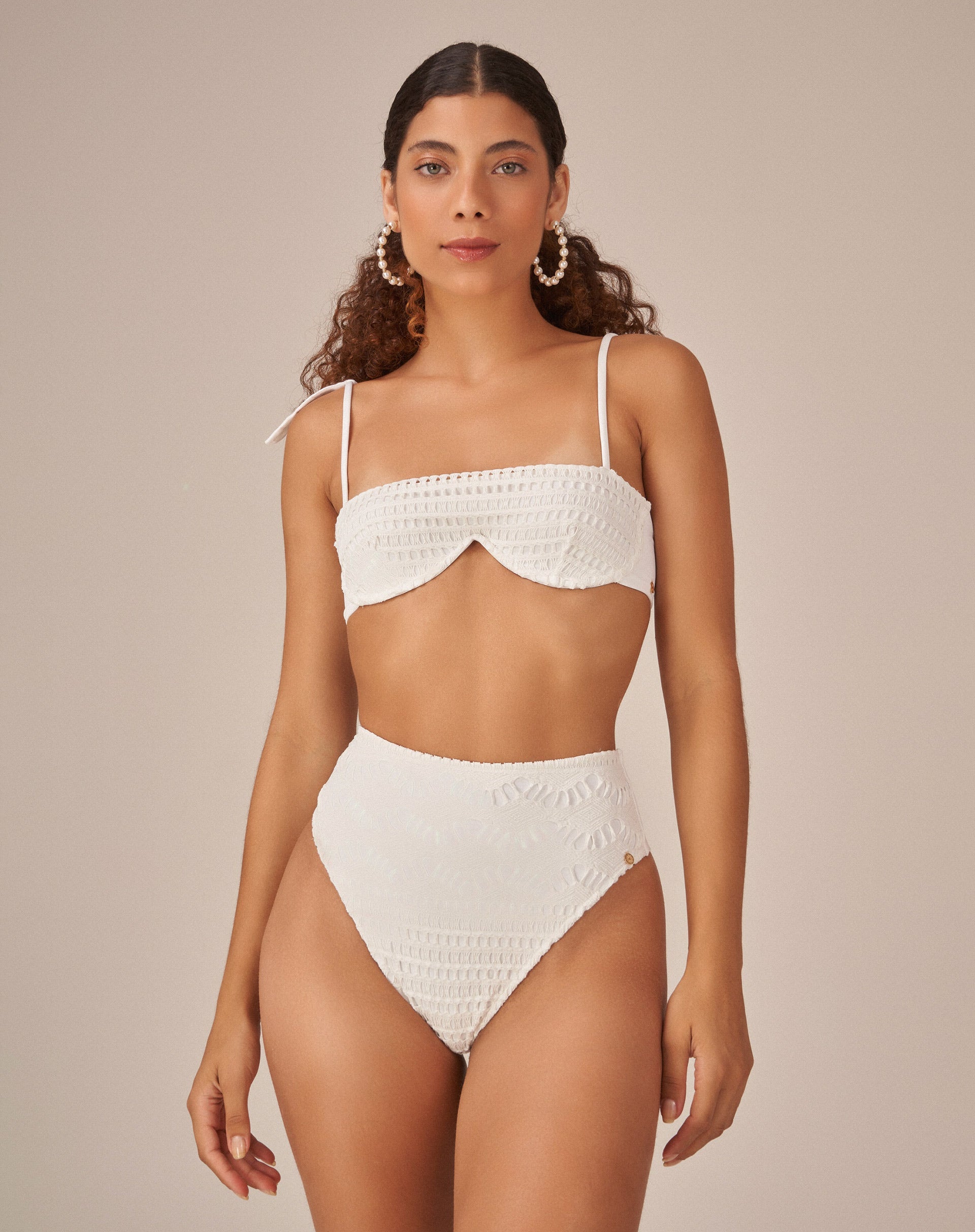 Imagem de uma modelo vestindo uma hot pant off white em tecido de macramê, vista frontal.