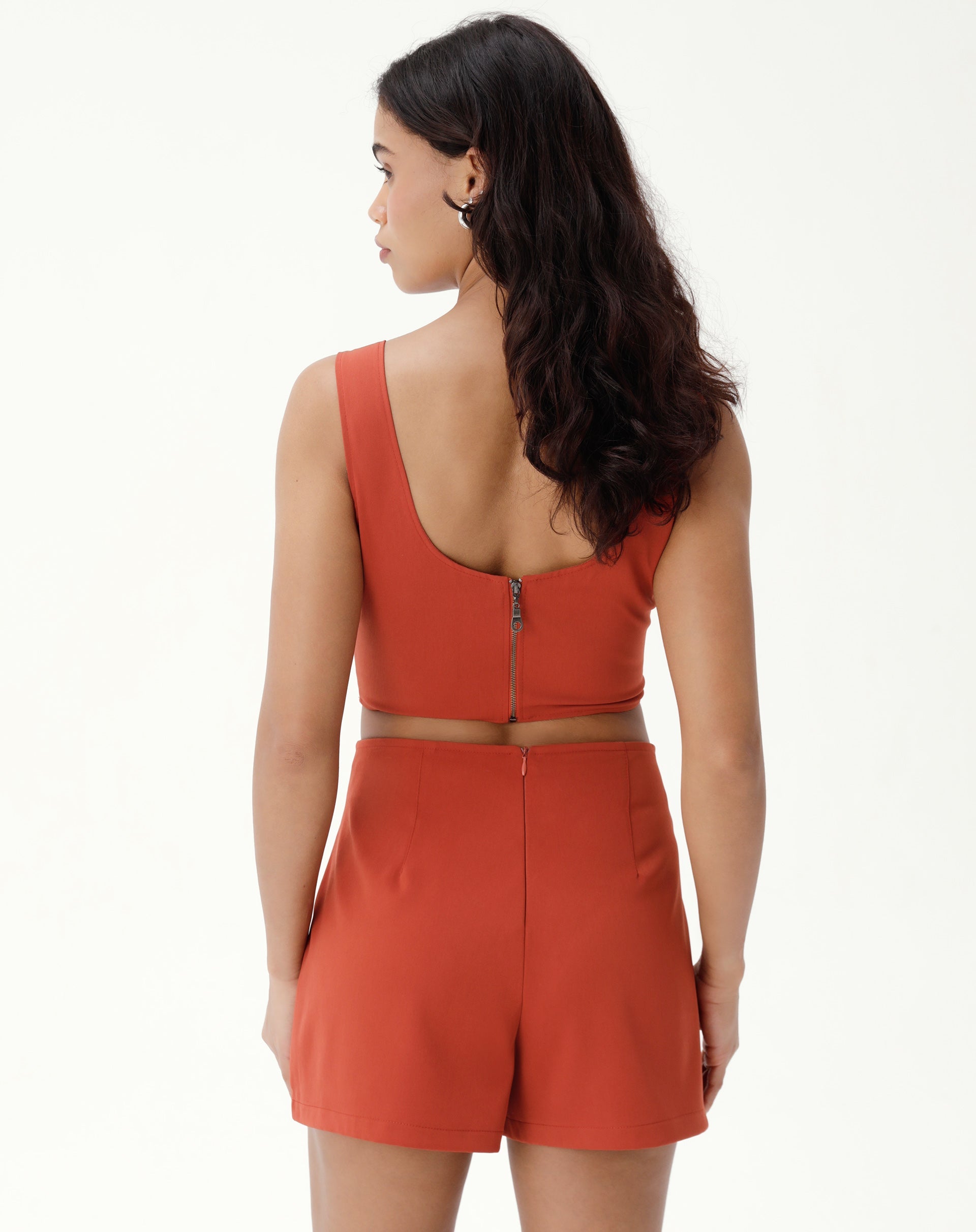 Vista traseira do shorts saia marrom mostrando o fechamento com zíper.