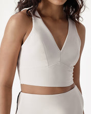 Detalhe do decote V e alças da blusa, mostrando o acabamento impecável.