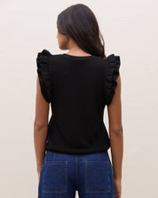 Vista traseira da blusa de tricot preta com manga de babados, mostrando o design das costas.