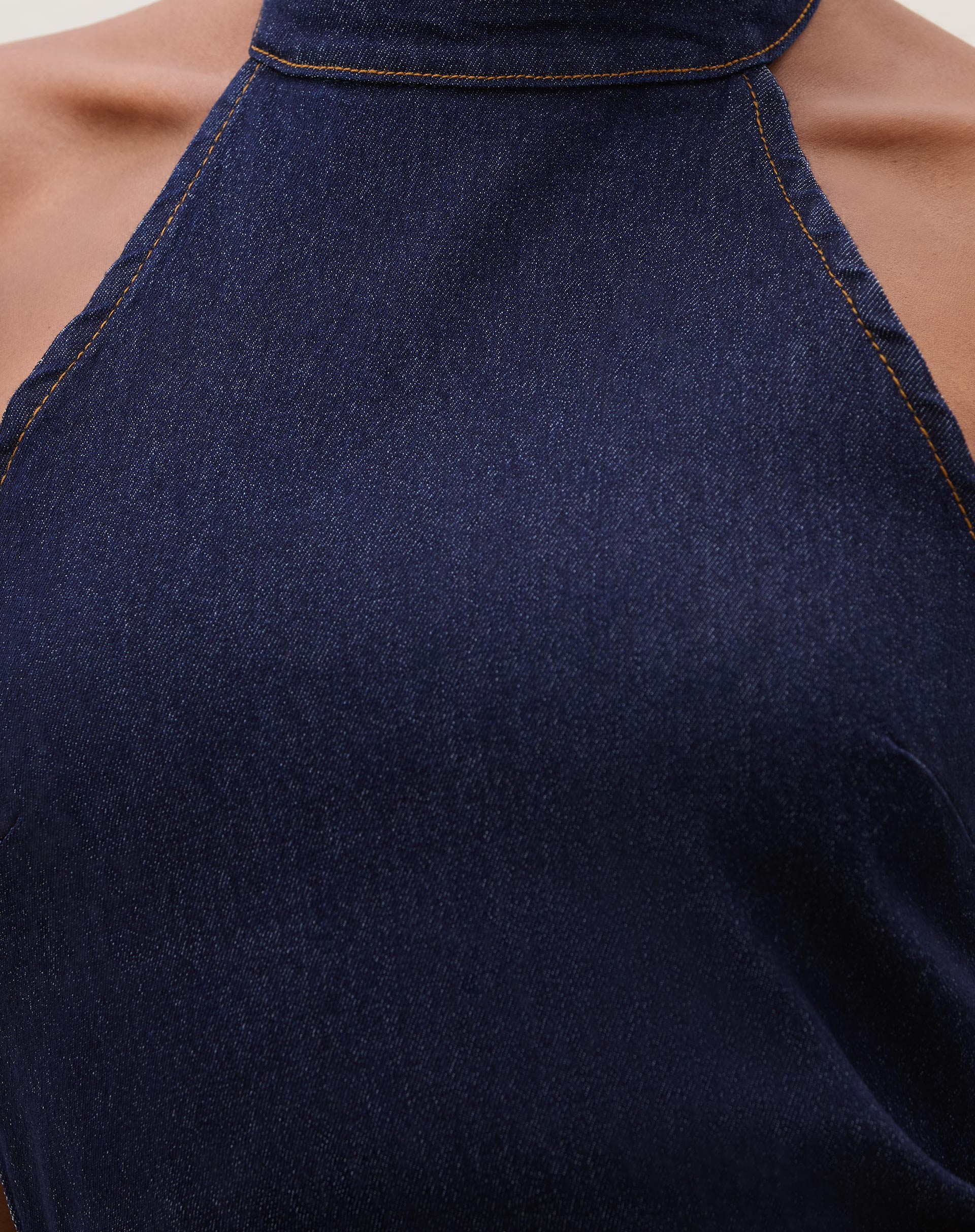 Close-up do tecido jeans azul escuro do vestido midi.
