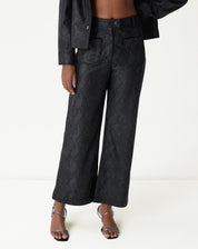 Detalhe traseiro da calça cobra PU preta mostrando bolso embutido e textura de escamas