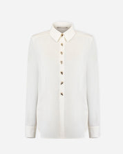 Foto do produto: camisa alongada off-white em fundo branco, vista frontal com botões decorativos e gola pontuda