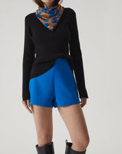 Close-up do shorts azul mostrando detalhes do cós e acabamento.